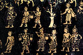 Wat Xieng Thong temple in Luang Prabang, Laos. Detail of the  intricate gold stencilling on black lacquer that decorate the walls of the sim. 